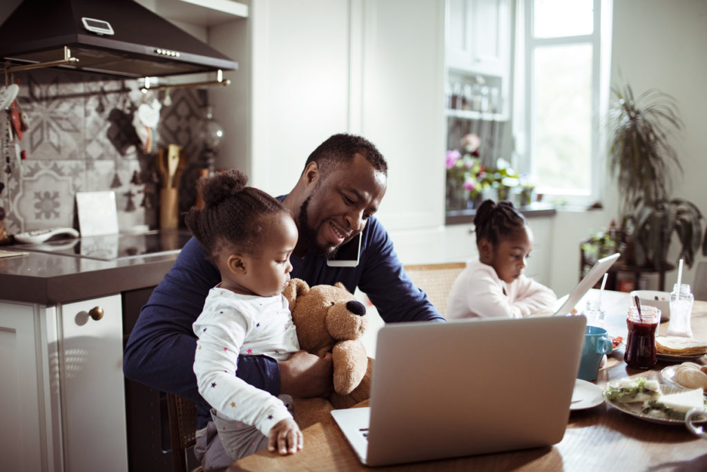 Young Family using a Laptop during Breakfast