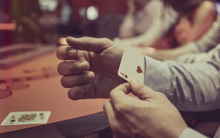 Man hiding an ace under in his sleeve at the casino