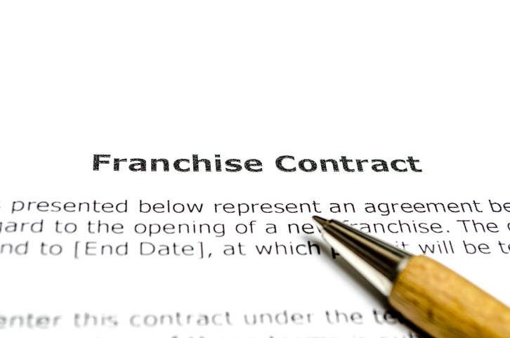 Franchise contract with wooden pen