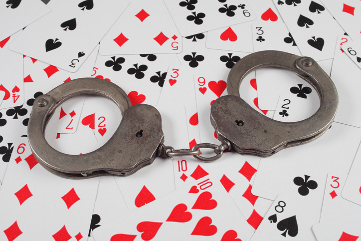 police handcuffs are on the background of game cards