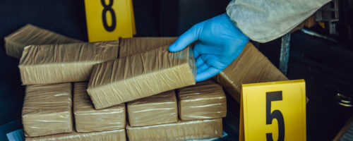 Packages of narcotics in car trunk. Drug smuggling.