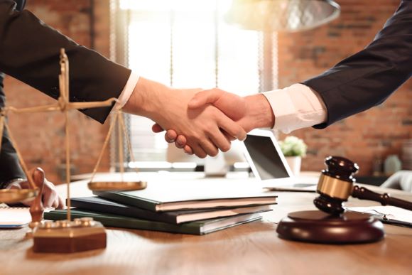 client shaking hands with criminal defense attorney